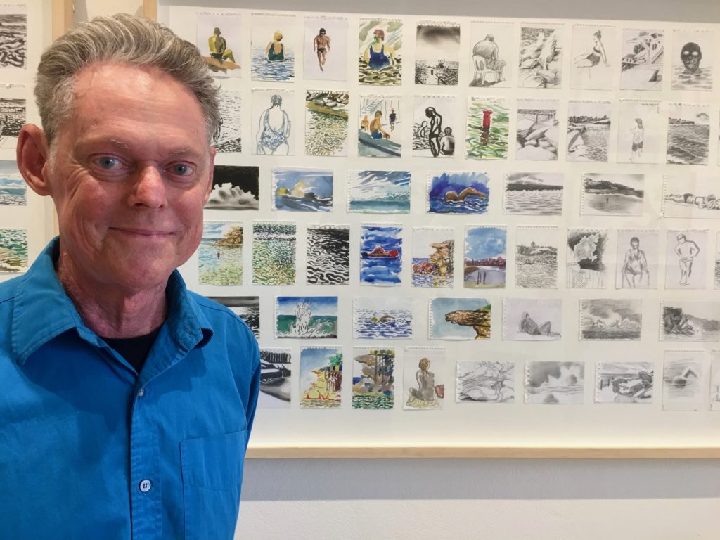 Cartoonist, Matthew Martin with some of the drawings in his exhibition at the Shapiro Gallery Woollahra, December 2018